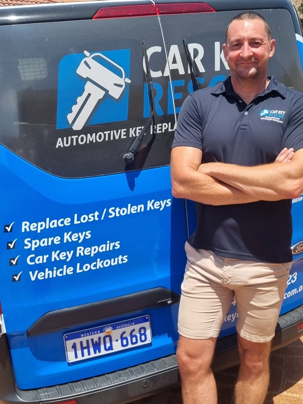 Car Key Rescue Perth mobile auto locksmith in uniform beside the company's branded service van